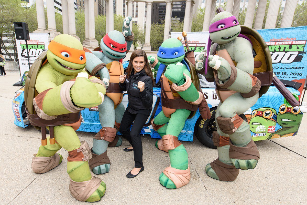 Ninja turtles pose in front of promo booth