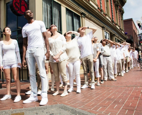 Syfy Comic Con workers line up to stare at sky in all white