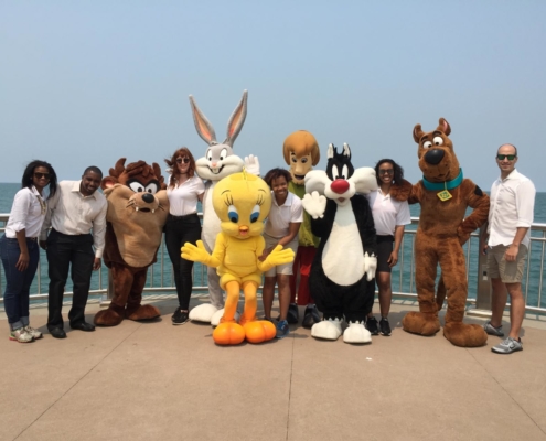Cartoon network mascots lined up on the deck of a cruise ship