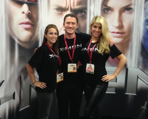x-men Comic con event staff in front of posters