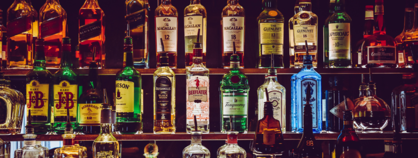 bottles of alcohol on an aesthetic dark shelf